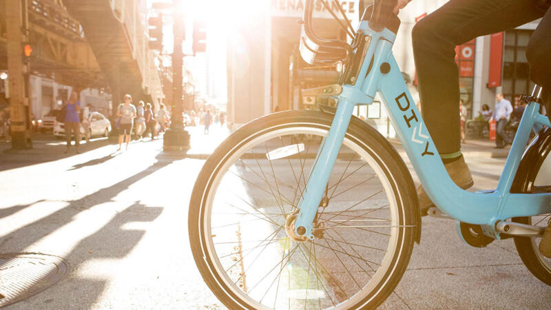 Divvy bike with rider in downtown Chicago