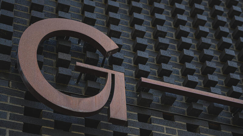 Green Line dark brick facade and metal logo