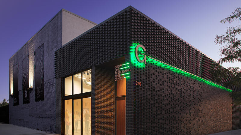 Evening view of Green Line Performing Arts Center and signage