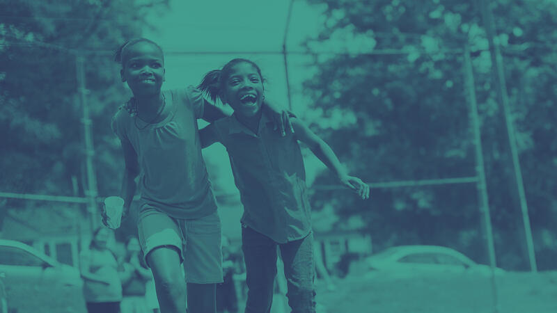 Two children playing together at a playground