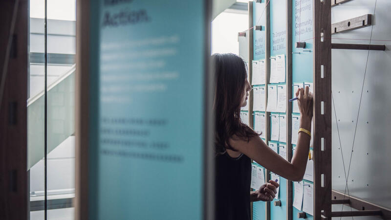 RWJF Action Shot of Young Woman Contributing to Crowd-Sourced Activity