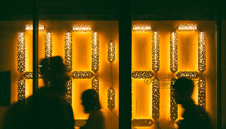 People walking past 88:88 Light Installation